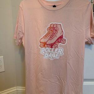 A pink roller babe shirt, bought from Francesca’s and is Alya brand.